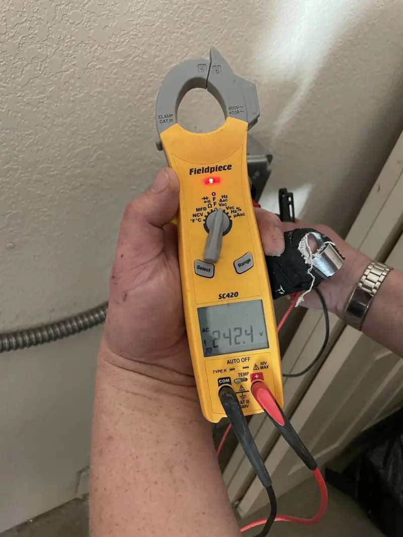 Voltage testing with clamp meter during Outlet Installation in Decatur